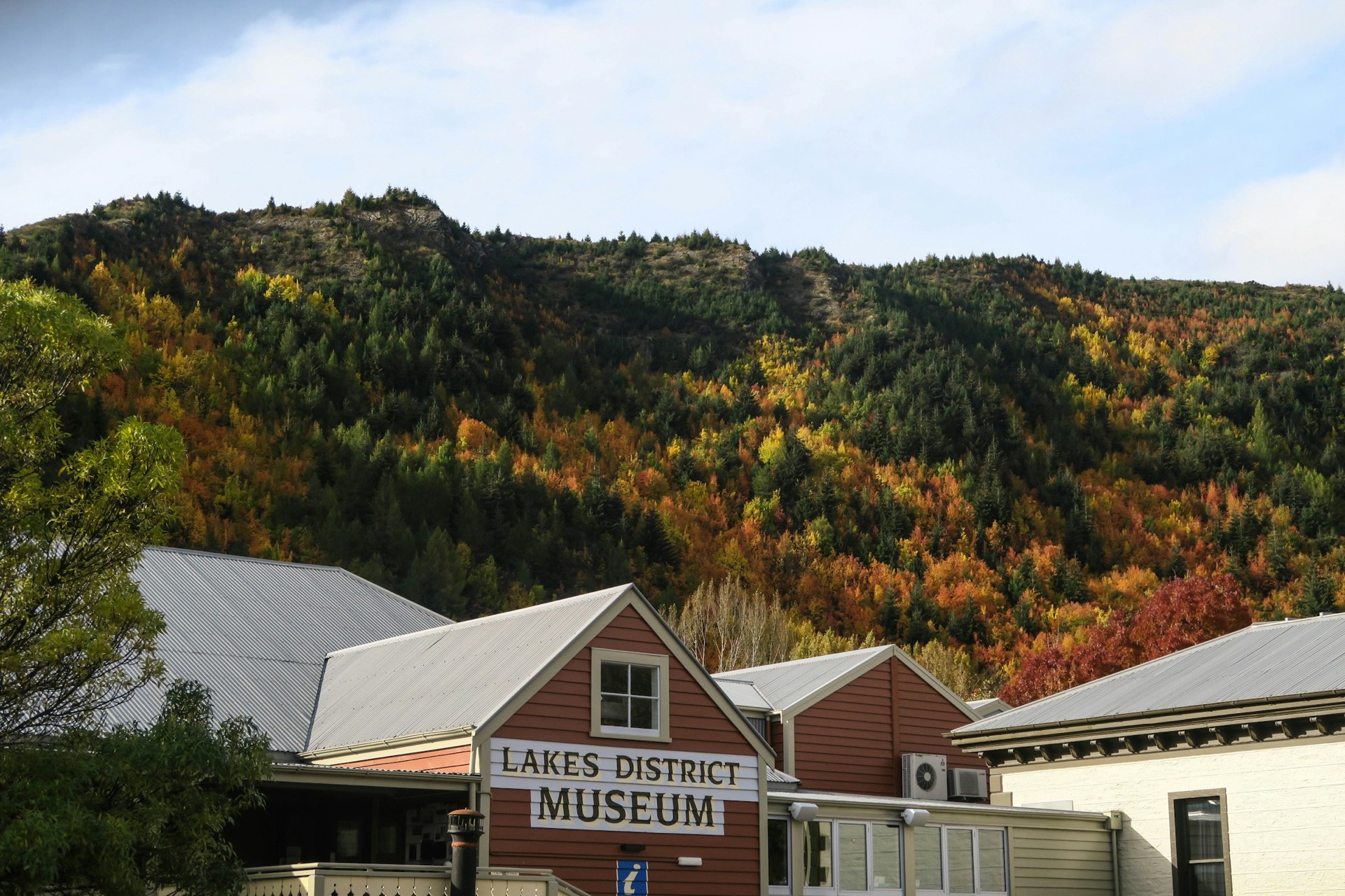 The Lakes District Museum on Arrowtown's main street, timber and stone under a clear sky.