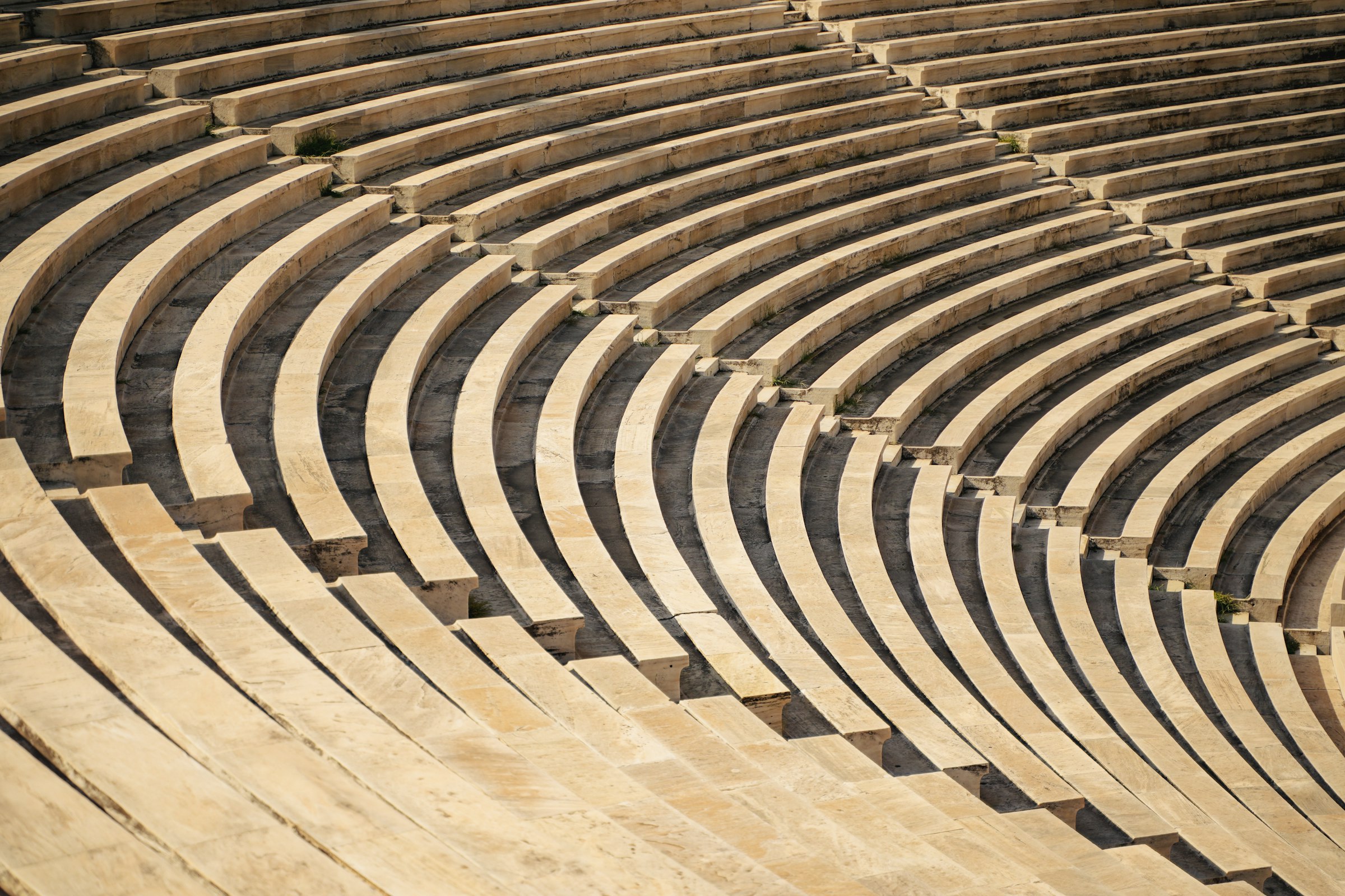 Curved rows of white marble seating in the Panathenaic Stadium.