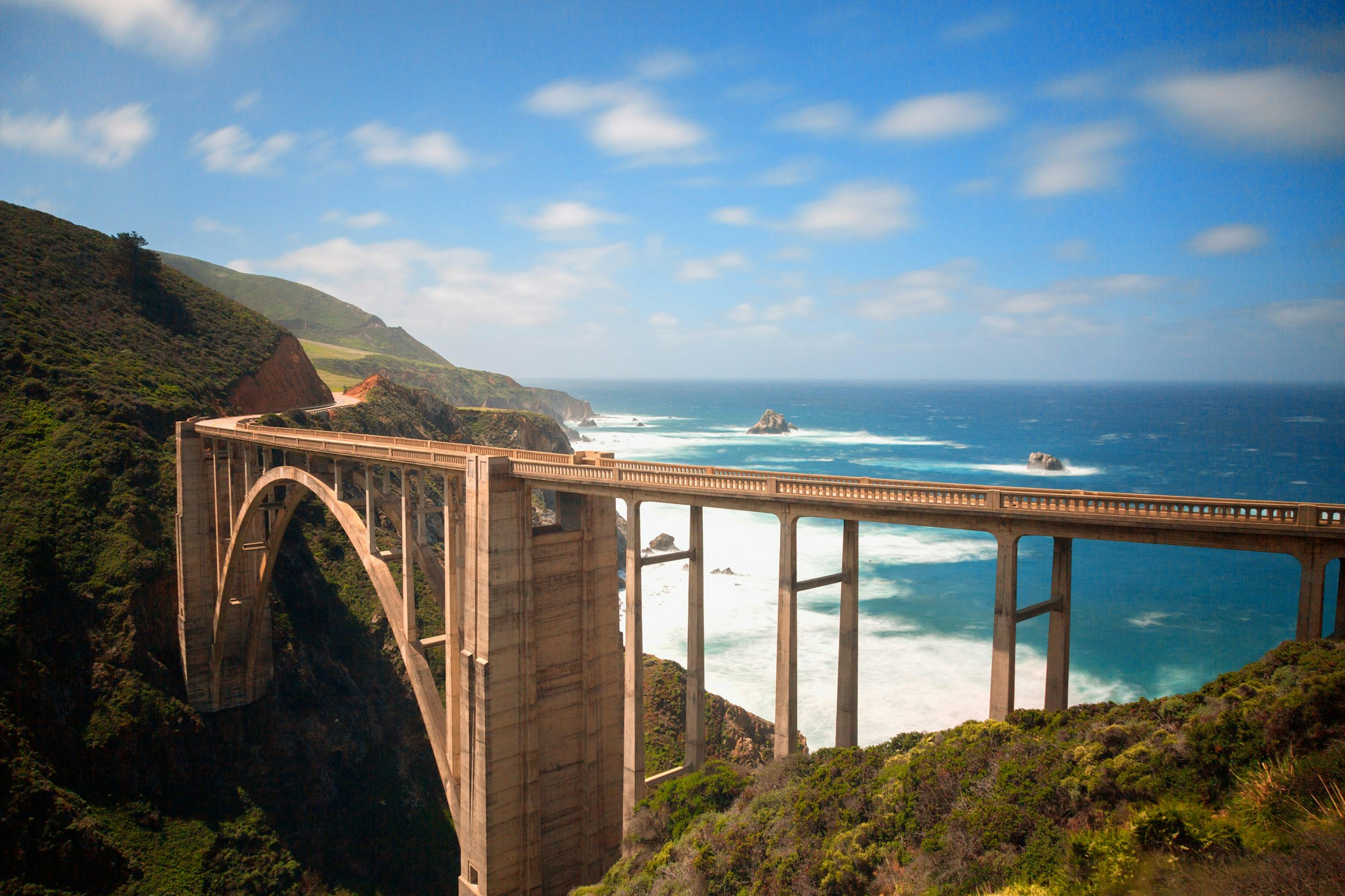 Bixby Creek Bridge seen from the roadside, the Pacific behind it.