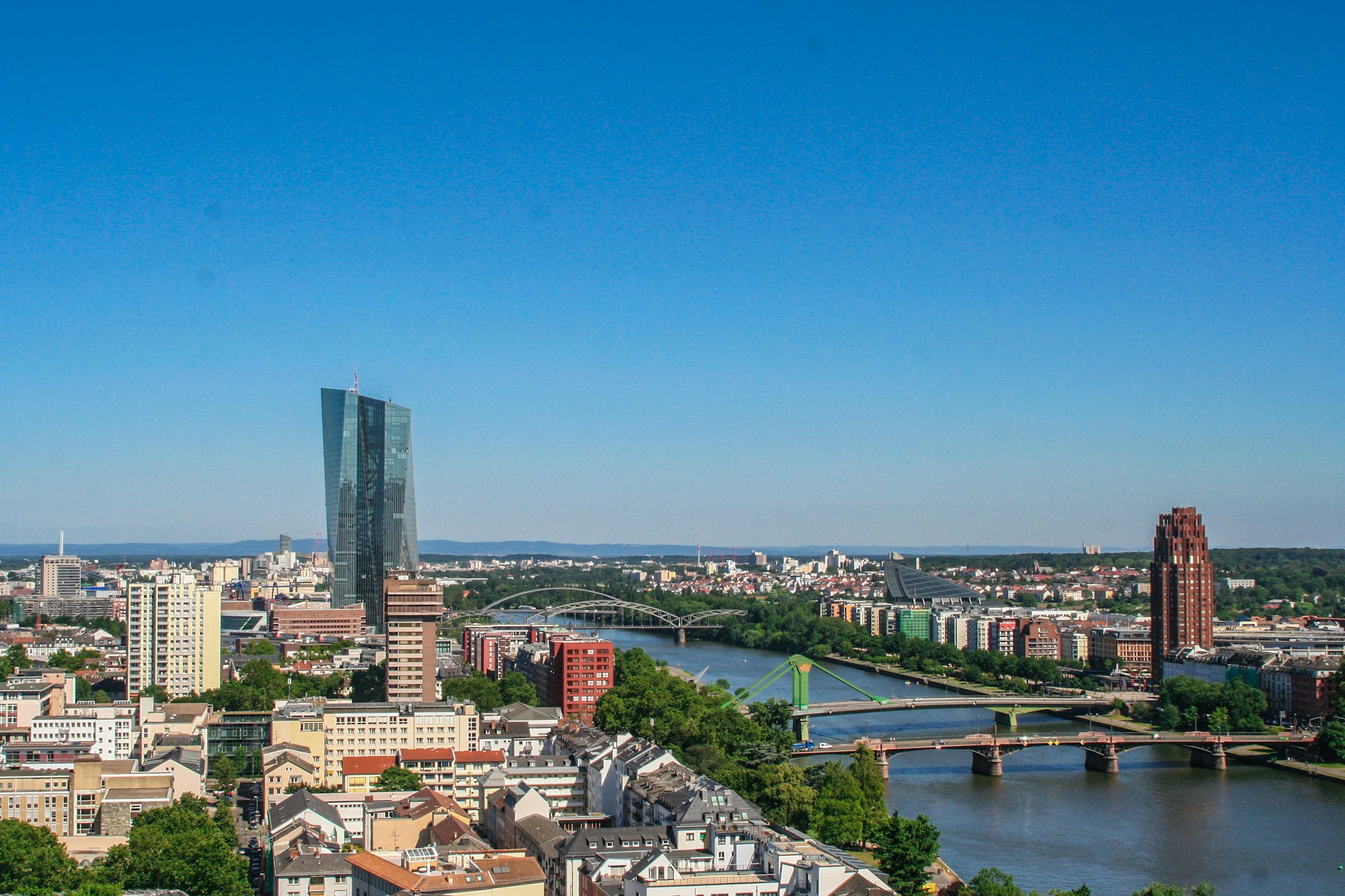 The river Main curving east through Frankfurt past several bridges, with the tower of the European Central Bank on the left.