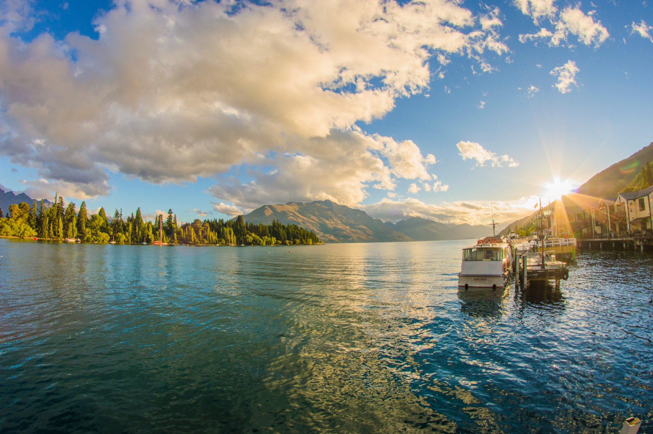 Queenstown Bay at sunset from Steamer Wharf, the mountains beyond the lake.